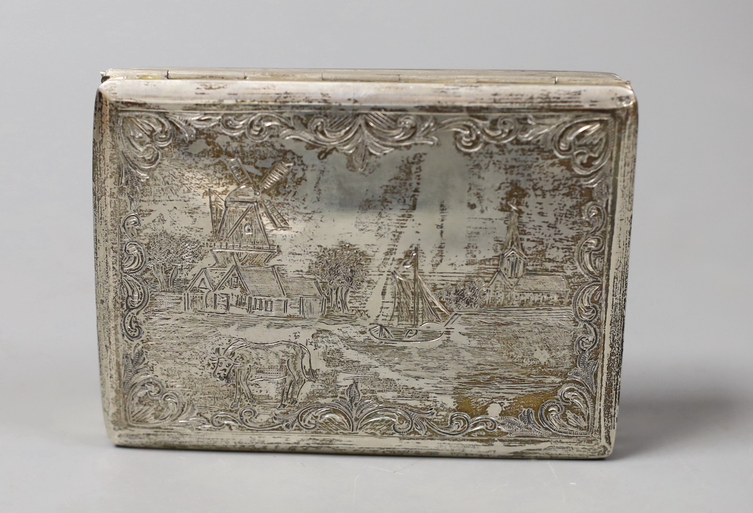 A 19th century Dutch 833 standard white metal rectangular box and hinged cover, engraved with countryside scene, 95mm, 102 grams.